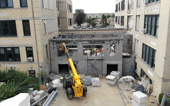 Construction site of Long Island School Additions with cranes and workers.