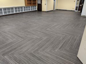 Empty school hallway with new commercial flooring installed during summer break
