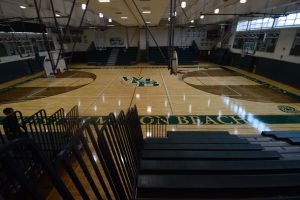 Gym floor in a school gymnasium with added acoustic treatments to manage sound levels