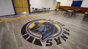 Safe, polished school cafeteria floor with custom logo, ready for students and compliant with safety standards