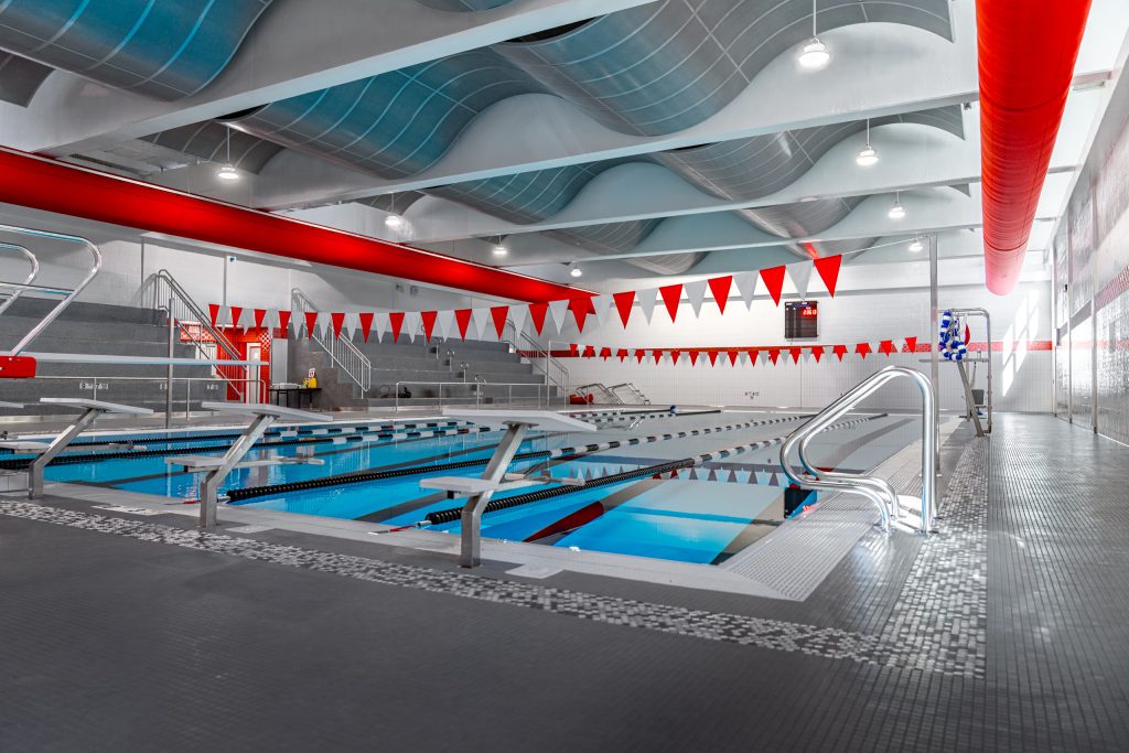 Wide view of the High School Pool with clear blue water and lane markers