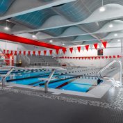 Wide view of the High School Pool with clear blue water and lane markers