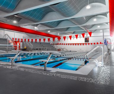 Wide view of the High School Pool with clear blue water and lane markers